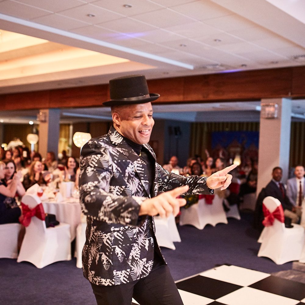 Guest in a top hat dancing across the dance floor at the awards evening
