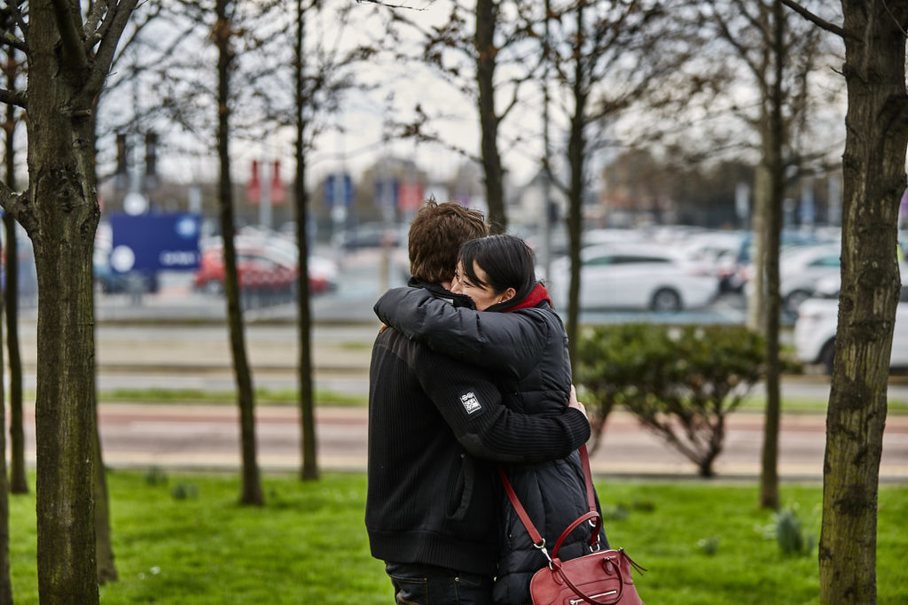 Couple hugging among young trees just after the proposal