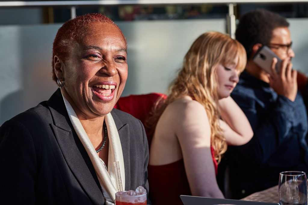 Guest laughing at the table at a 60th birthday party