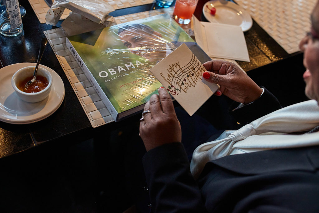 Birthday card being read at the table beside a cup of coffee