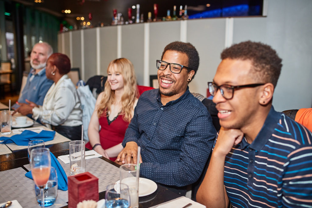 Guests laughing together along the birthday table