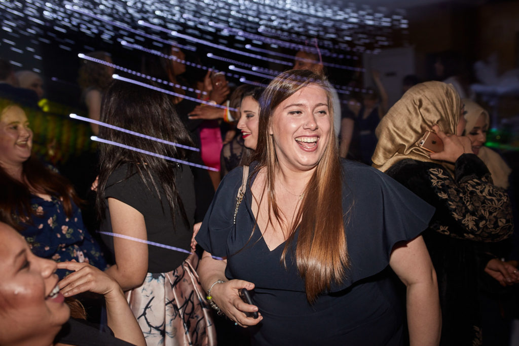 Guest laughing on the dance floor under a starlight ceiling
