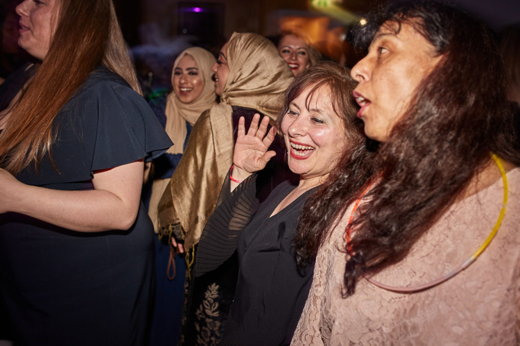 Guests singing along together on the dance floor