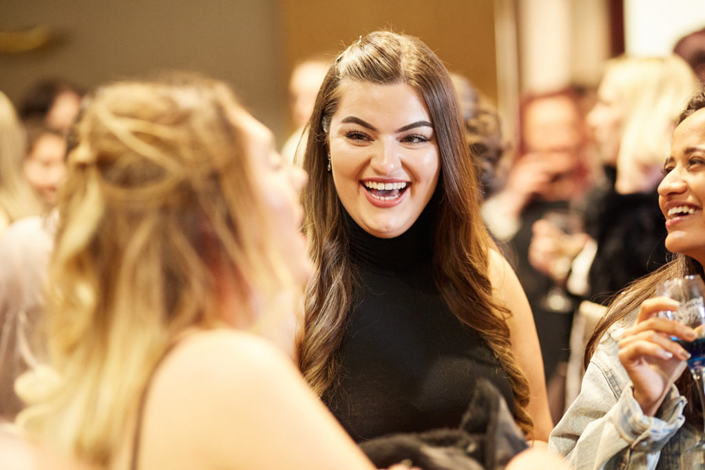 Guest laughing with a colleague at an awards evening at the Elstree Holiday Inn