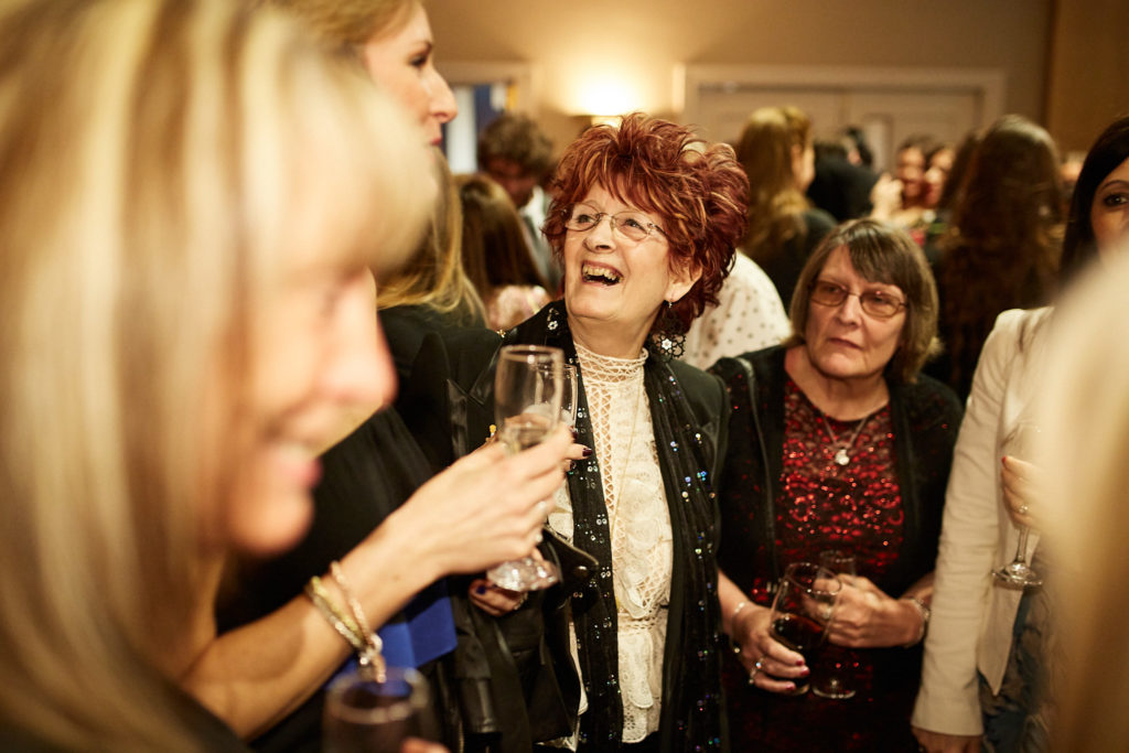 Guests laughing together over drinks
