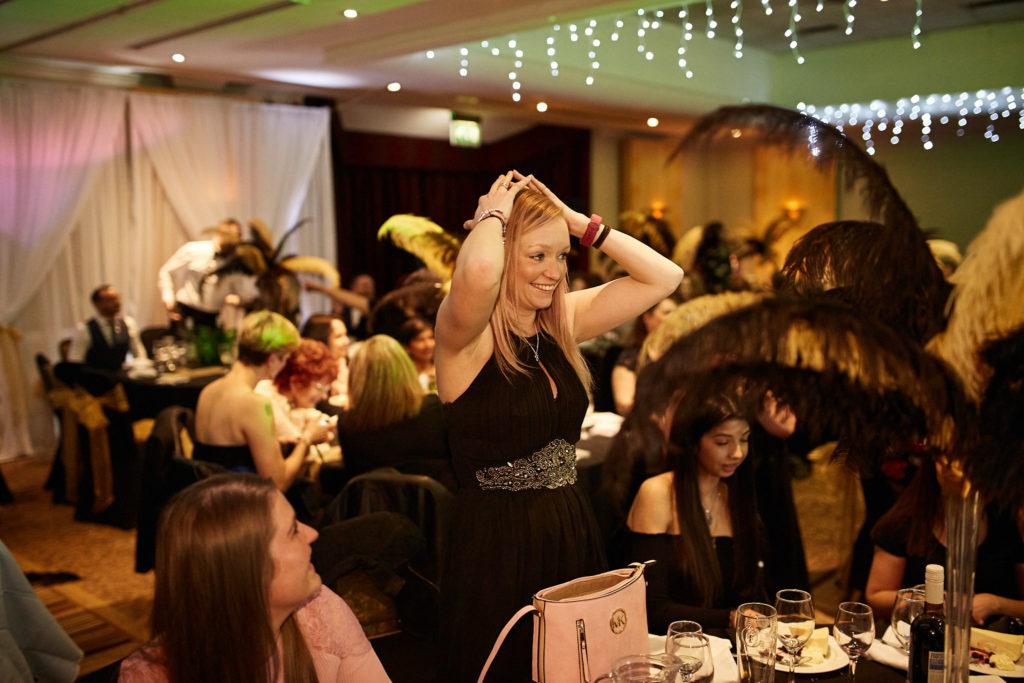Guest fanning herself at the table during the awards dinner