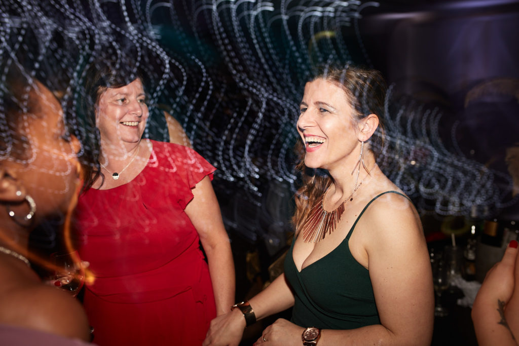 Guests laughing together on the dance floor at the Elstree Holiday Inn