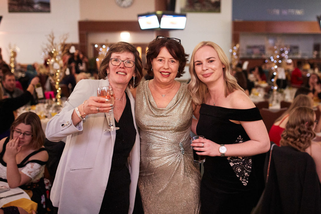 Three guests posing together at the awards evening