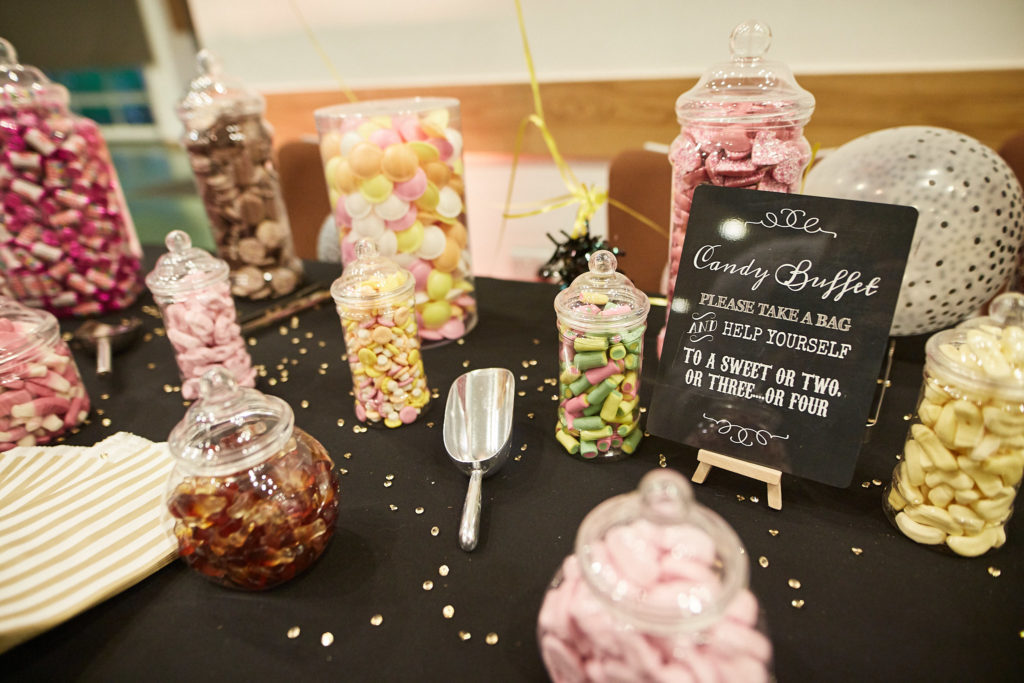 Sweet buffet with jars of sweets and a chalkboard sign