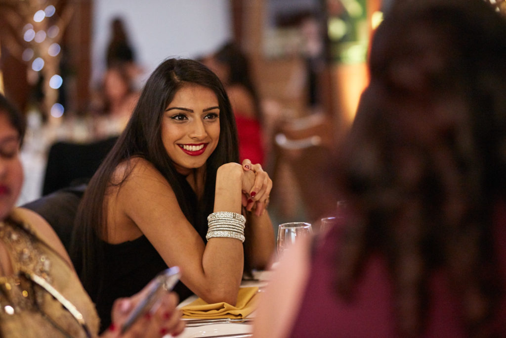 Guest smiling over her shoulder at the table