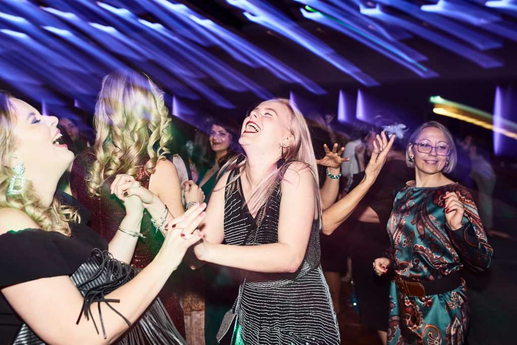 Guests laughing as they dance at the awards evening