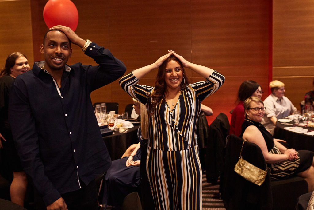 Two guests with their hands on their heads in surprise