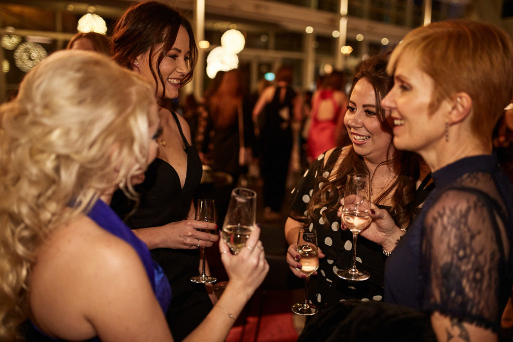Guests laughing together over drinks