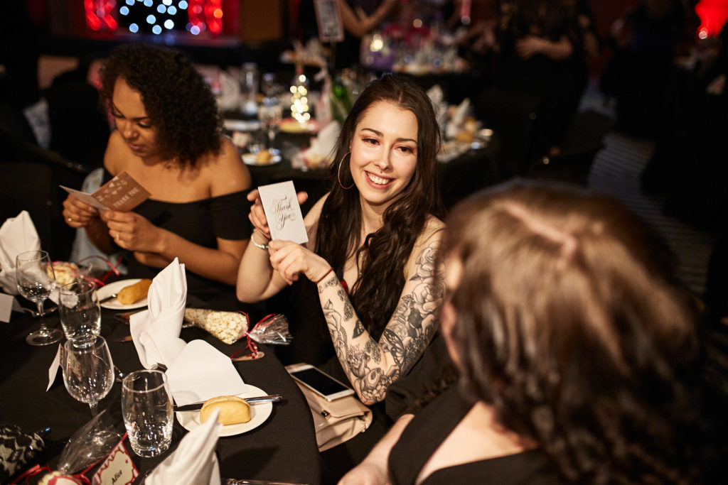 Guests smiling at their table during the awards dinner