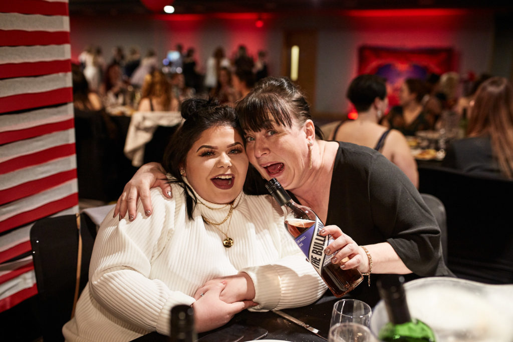 Two guests laughing together at their table