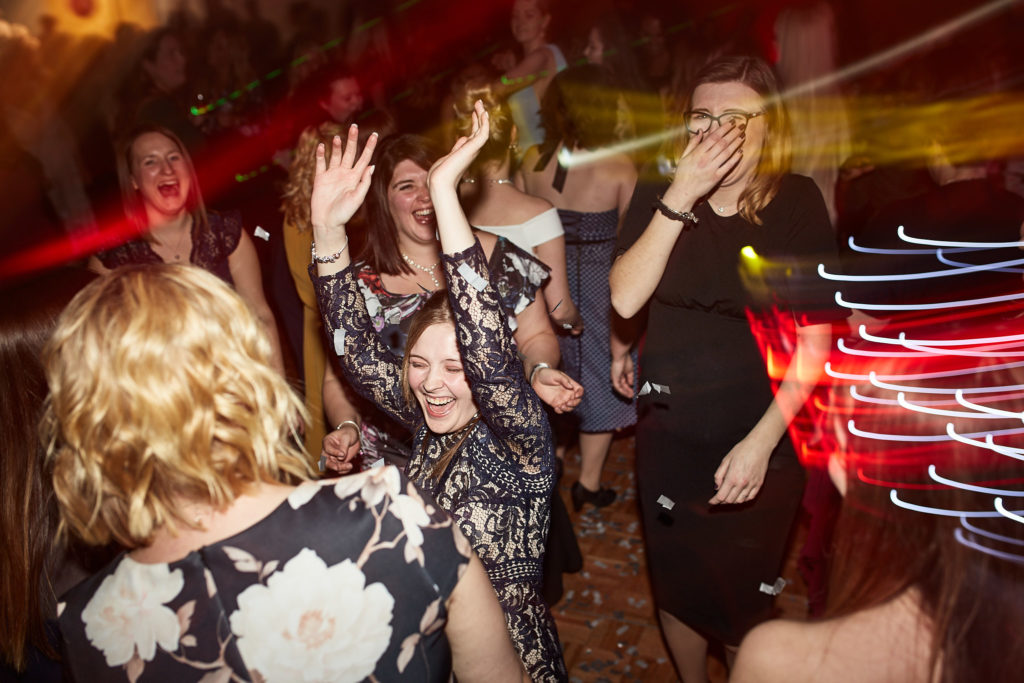 Guests dancing with their arms in the air