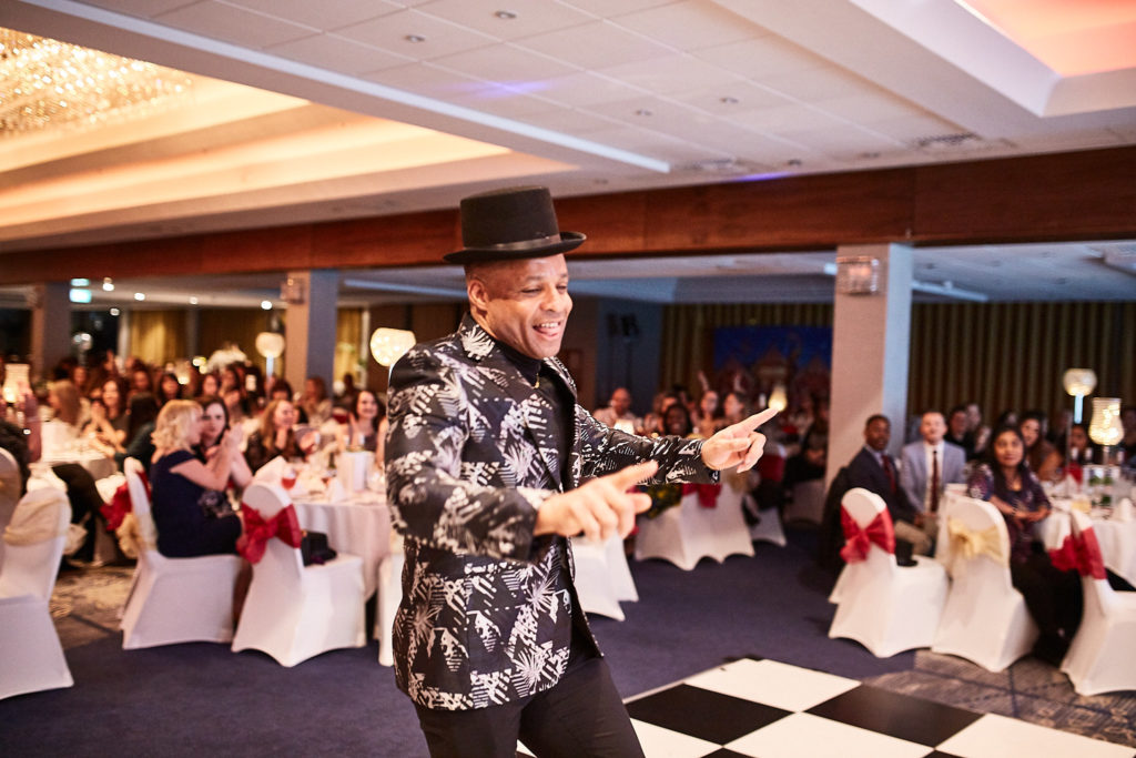 Guest in a top hat dancing across the dance floor at the awards evening