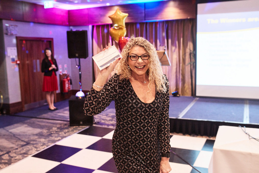 Award winner waving as she collects her award