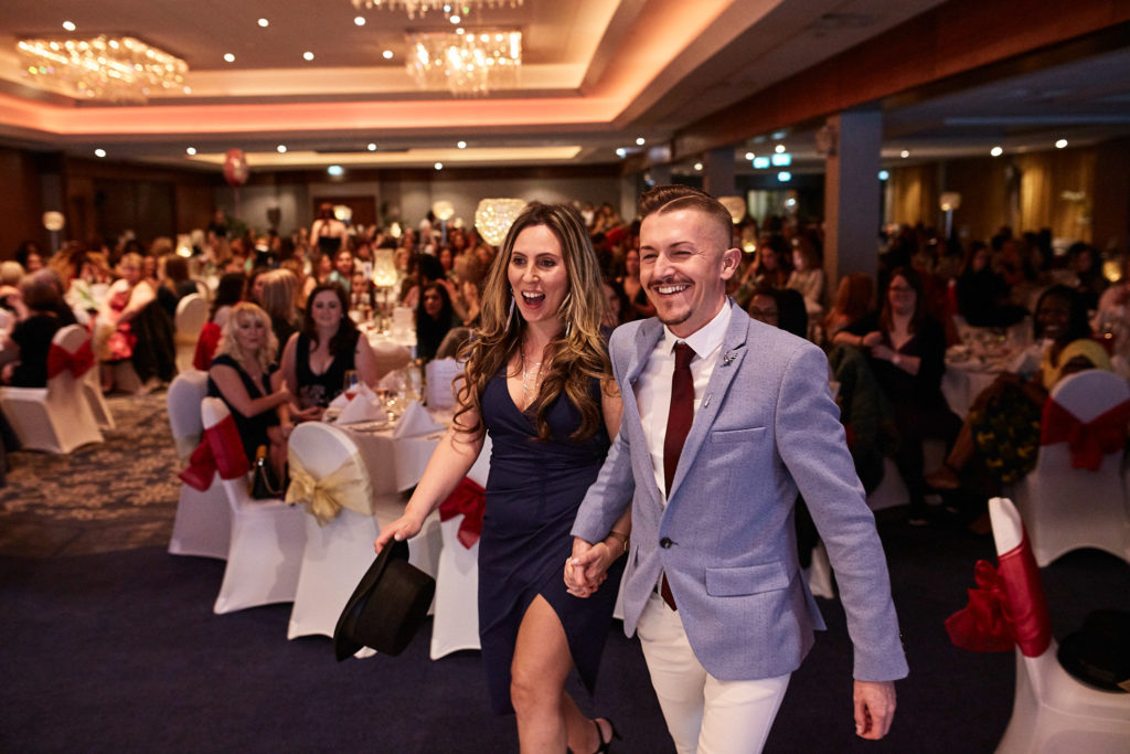 Two award winners walking through the hall hand in hand
