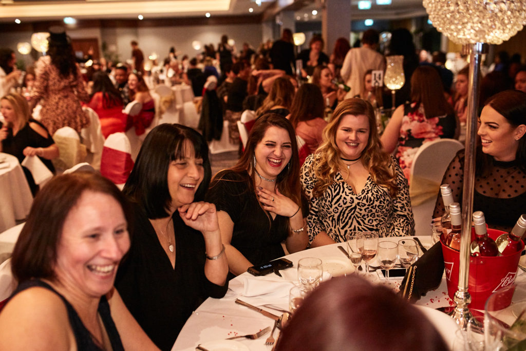 Guests laughing together at their table