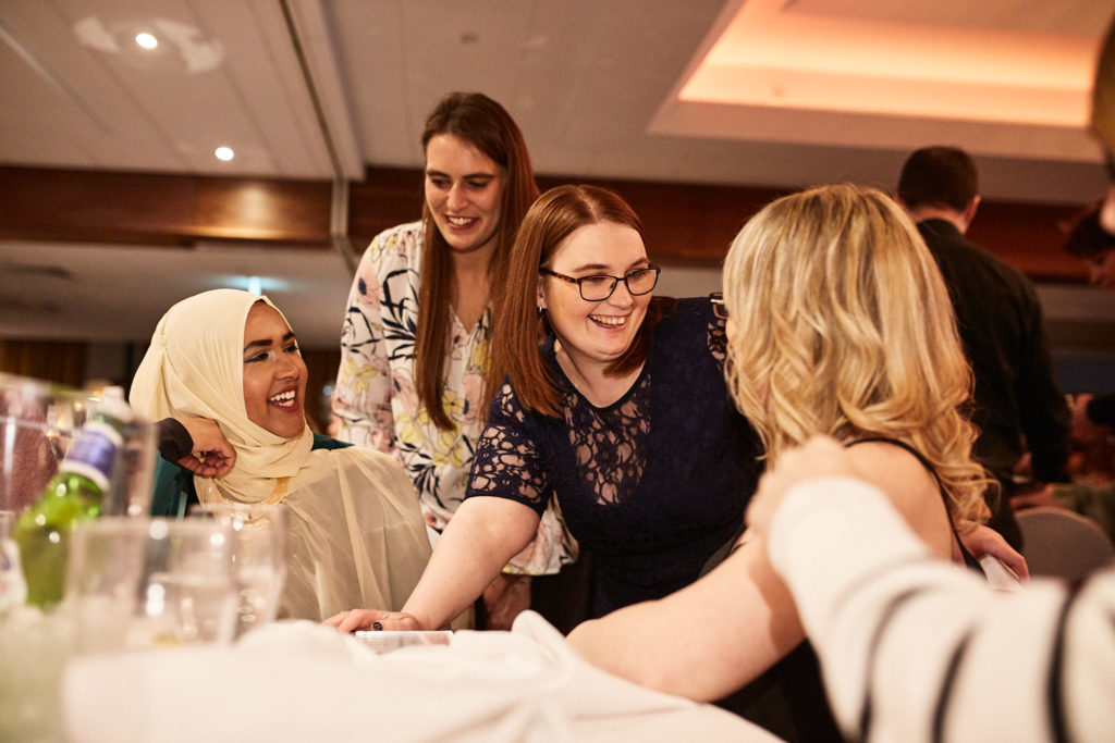 Guests laughing together at their table