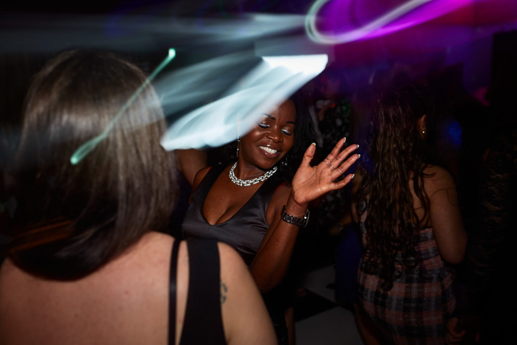 Guests dancing among streaks of light