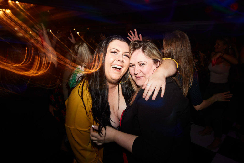 Two guests hugging on the dance floor