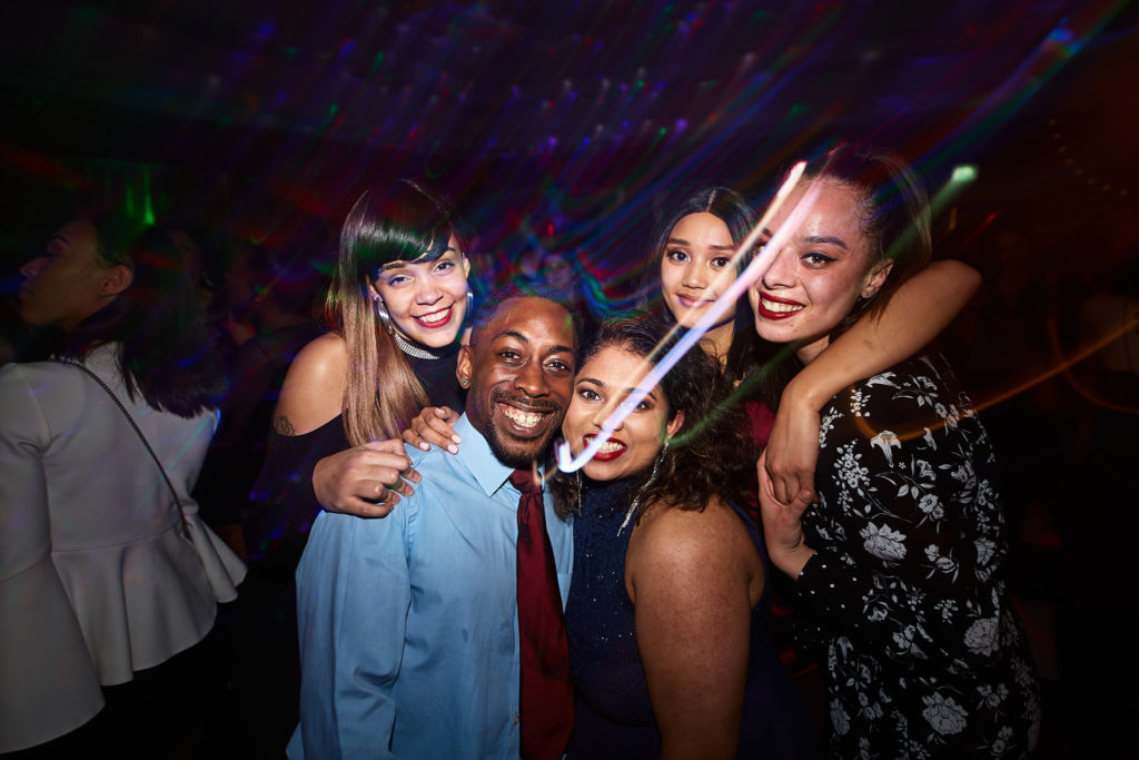 Group of guests posing together on the dance floor