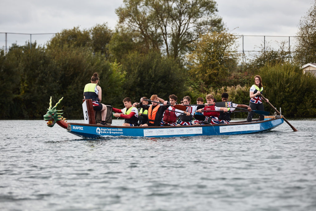 Dragon boat crew paddling across the lake at Fairlop Waters