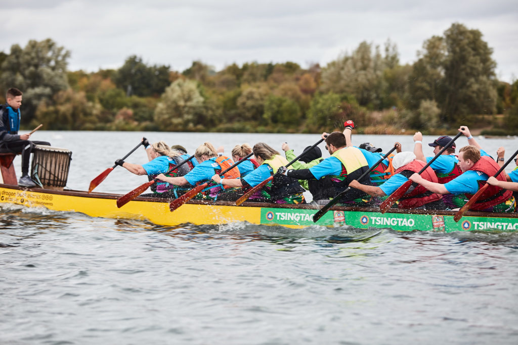 Two dragon boats racing side by side on the lake
