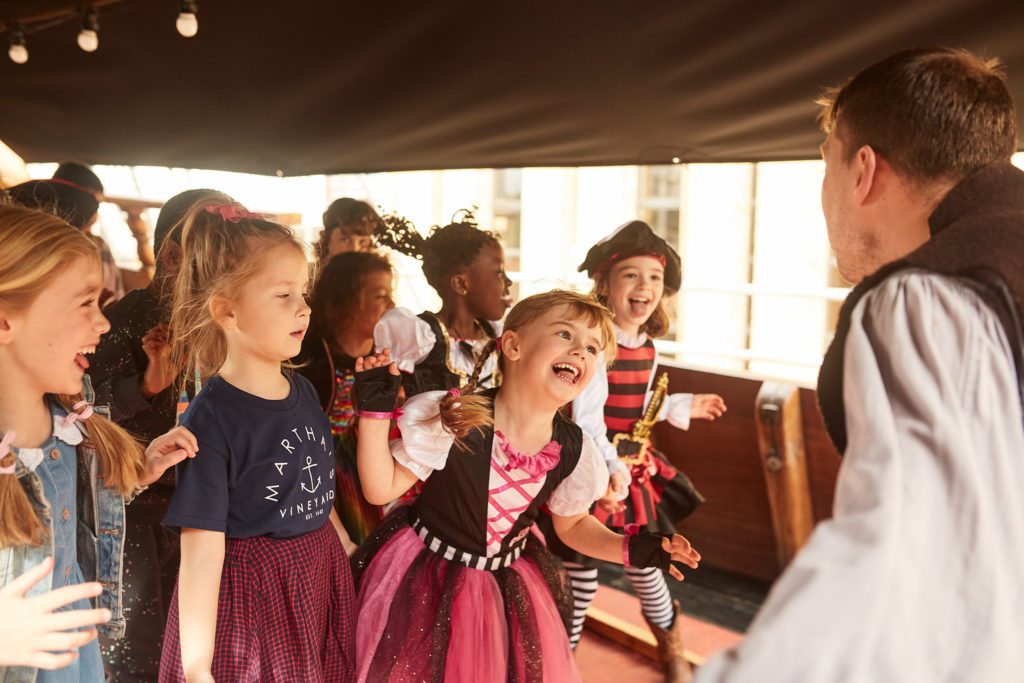 Children watching a pirate entertainer on deck