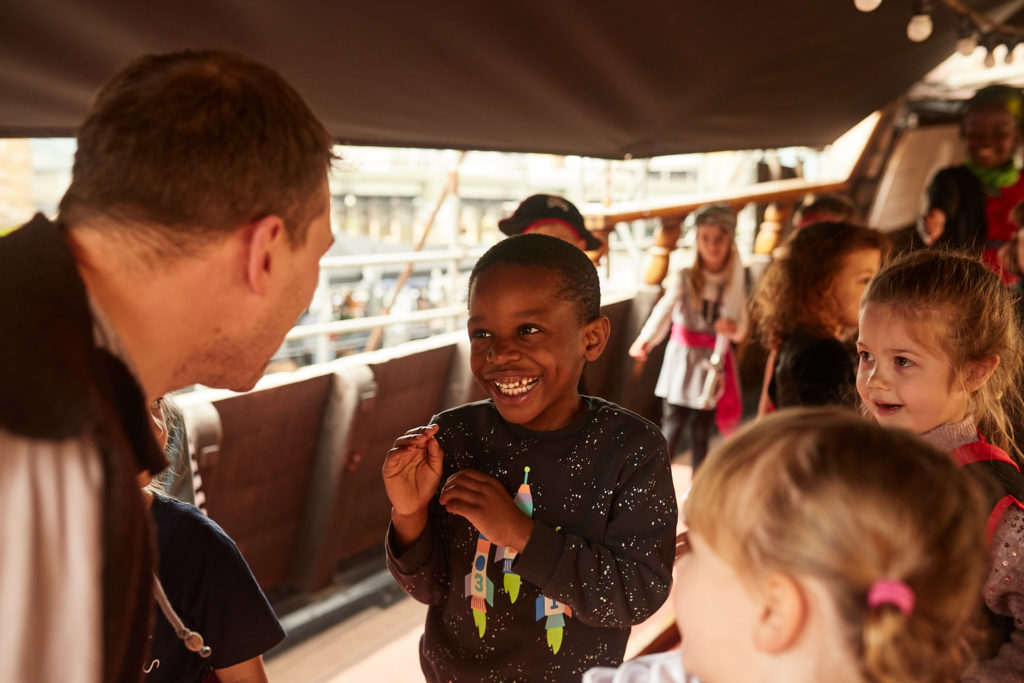 Pirate entertainer talking to the children on deck