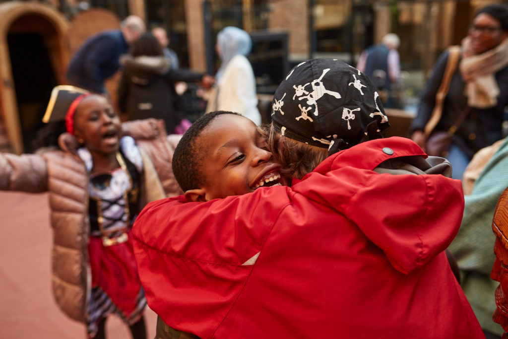 Children hugging at a pirate birthday party on the Golden Hinde in London