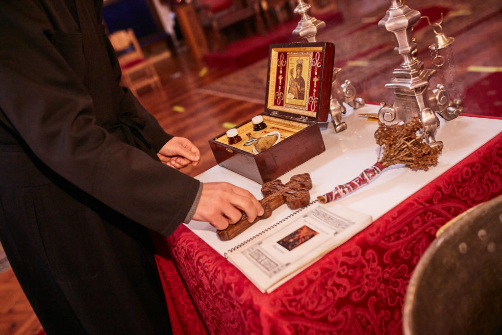 Priest preparing the table for an Orthodox baptism