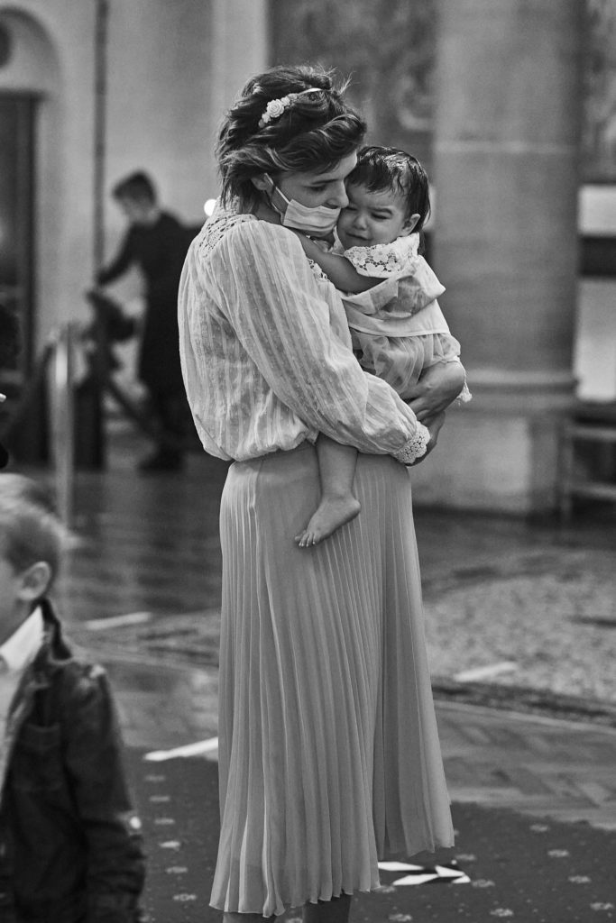 Black and white photo of a mother comforting her daughter in church