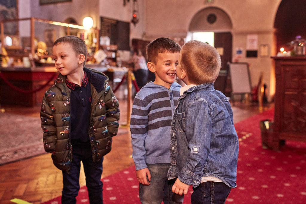 Three boys standing together in the church