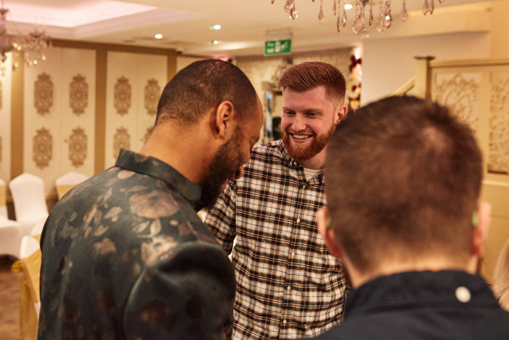 Guests laughing together at the mehndi