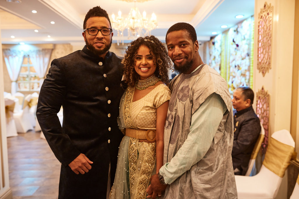 Three guests posing together at the mehndi