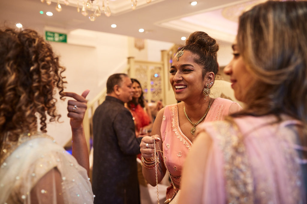 Guests in embroidered outfits talking together