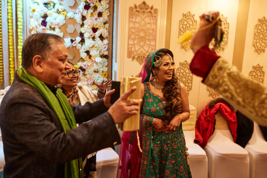 Guest filming on his phone as the bride dances