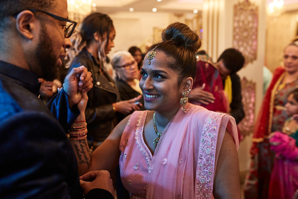 Guest having henna applied as friends look on