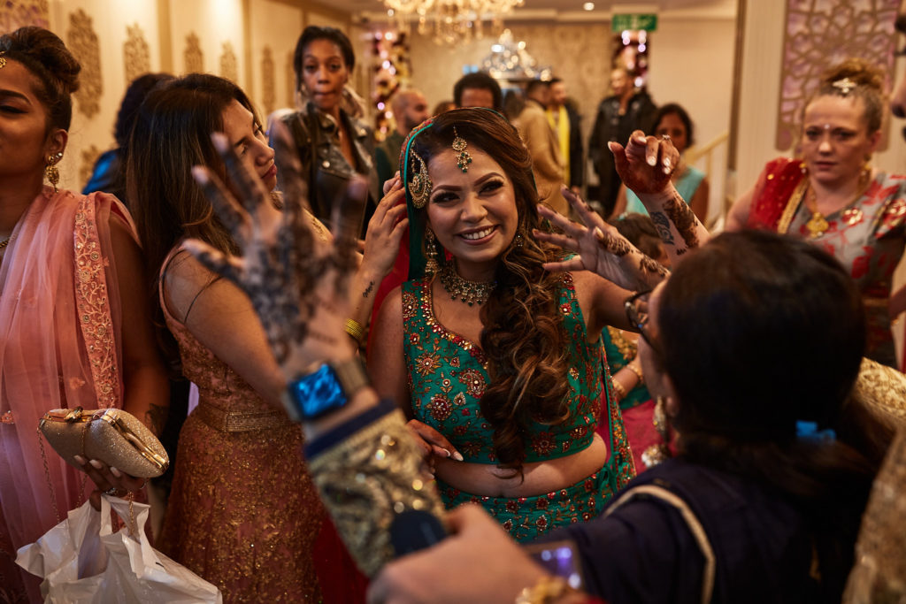 Bride-to-be laughing in the middle of a crowd of guests