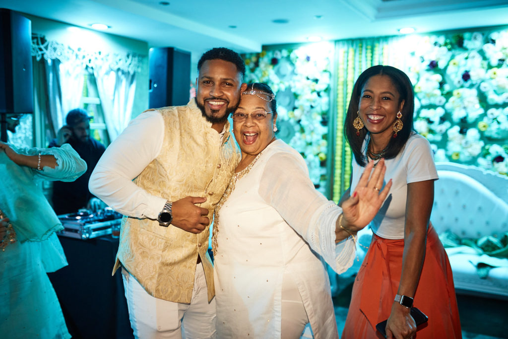 Three guests smiling together on the dance floor