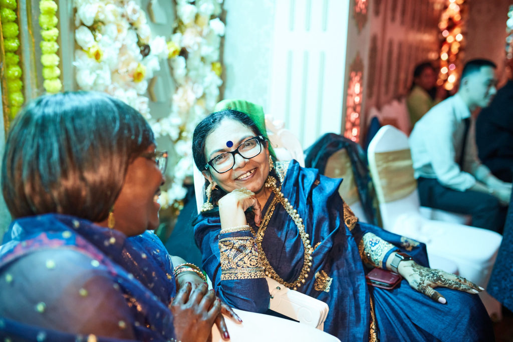 Two guests laughing together at the table