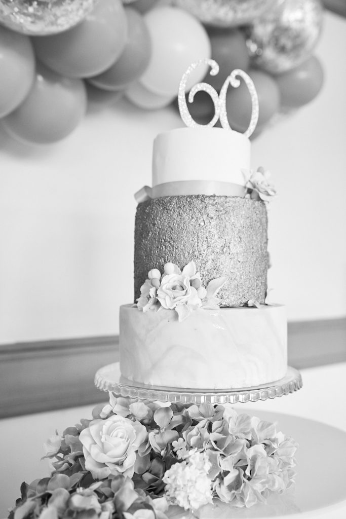 Black and white photo of a three-tier 60th birthday cake with a glittery middle tier