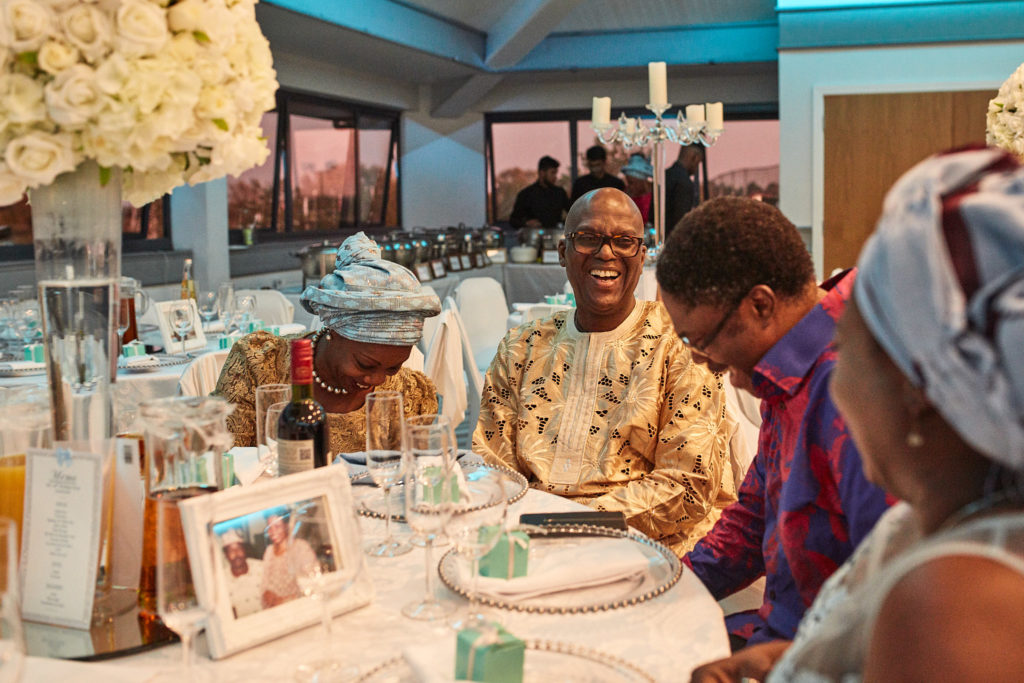Party guests laughing together at their table