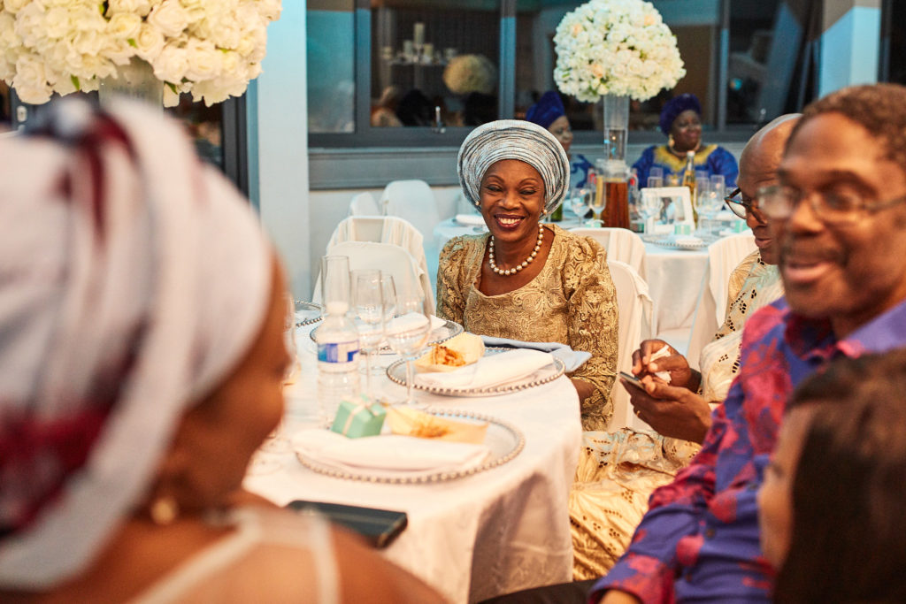 Guests smiling across the table at a 60th birthday party