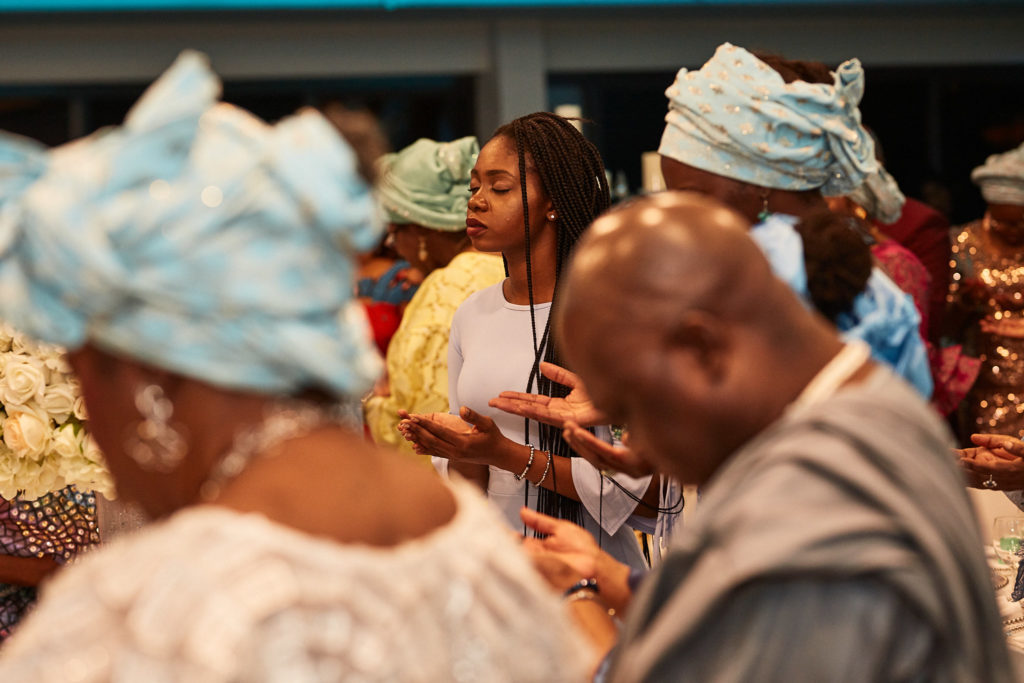 Guests in pale blue head ties laughing together