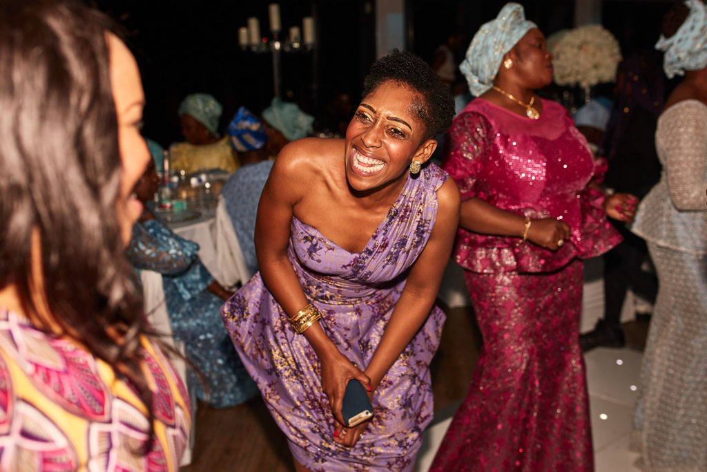 Guests laughing as they dance at the birthday party