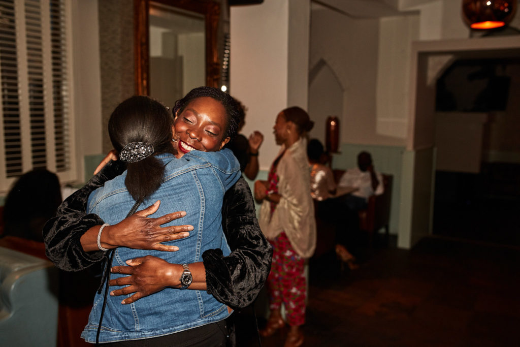 Two guests hugging at the birthday party